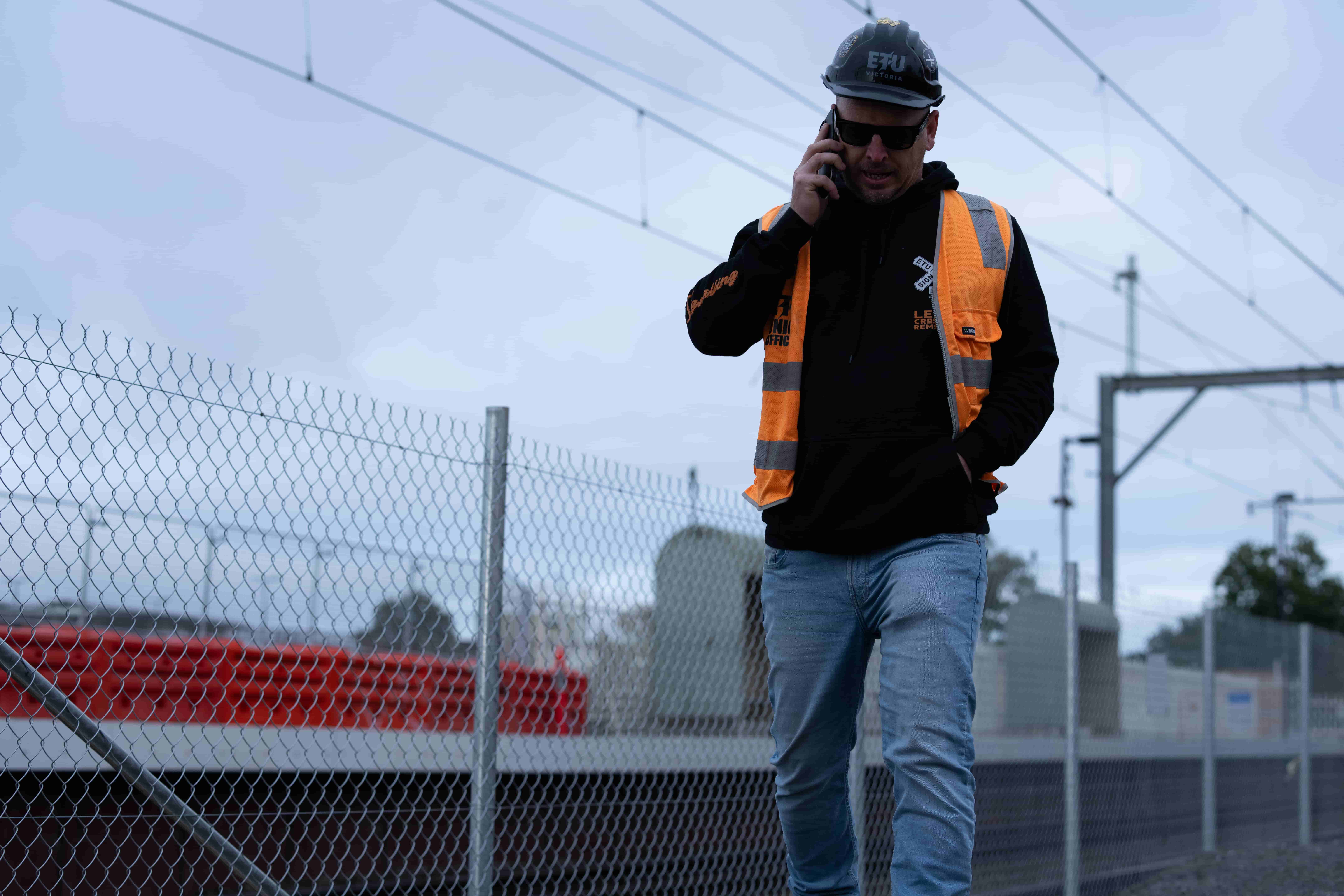 ETU Victoria Organiser Mark Connelly taking phone call to member on Level Crossing jobsite