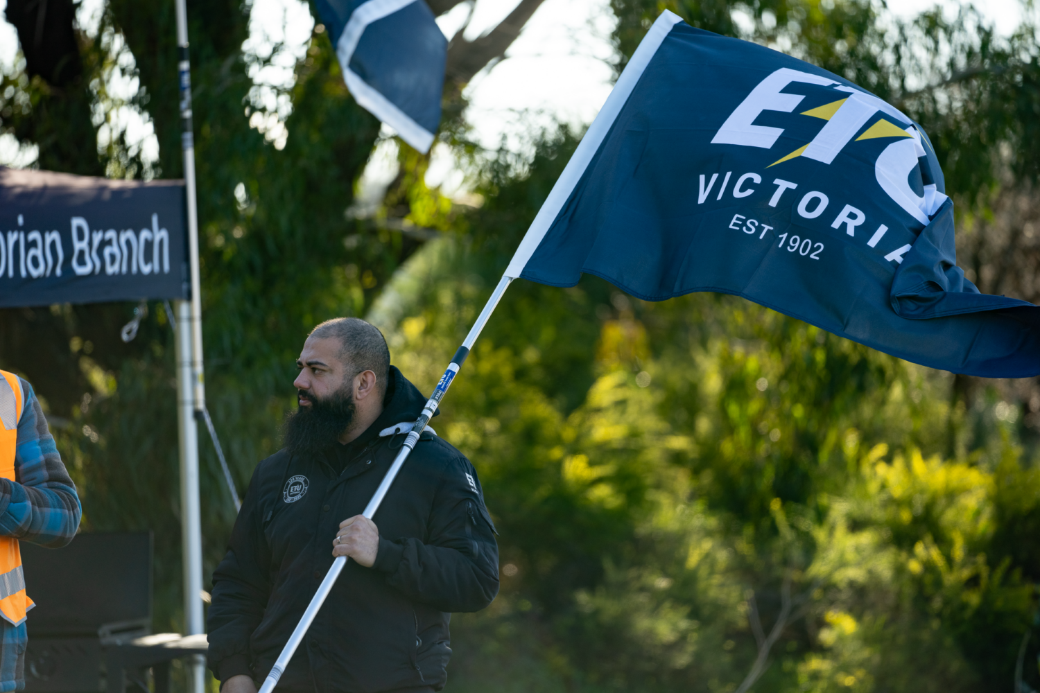 Muss Amiry holding an ETU Victoria flag